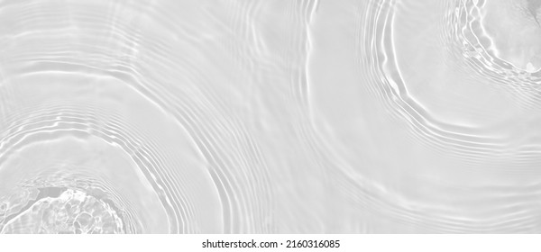 Abstract summer banner background Transparent beige clear water surface texture with ripples and splashes. Water waves in sunlight, copy space, top view. Cosmetics moisturizer micellar toner emulsion - Shutterstock ID 2160316085