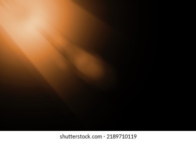 Abstract sun flare over black background. lens flare effect Golden sun light.
