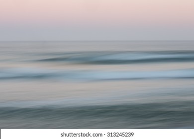 Abstract sunrise ocean with sky background with blurred panning motion causing soft feel