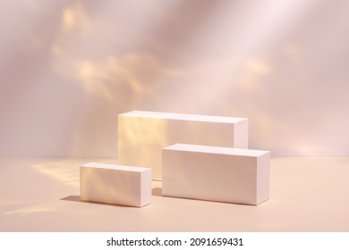 Abstract surreal scene - empty stage with three rectangle white podiums on pastel pink and gold colored background. Pedestal for cosmetic product packaging mockups display presentation