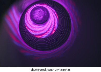 Abstract swirl tunnel with violet light on a background pattern textured for design.
