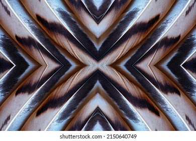 Abstract symmetric pattern of colorful feathers of wild duck as background close-up. Ornamental surreal tracery of bird feathers. The image with mirror effect.