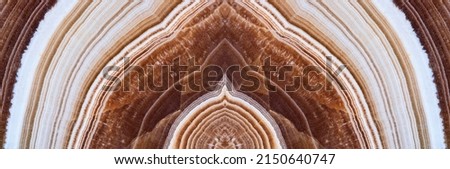 Abstract symmetric pattern of marble onyx polished slice. Amazing patterns and textures of slice of minerals for background. The image with mirror effect