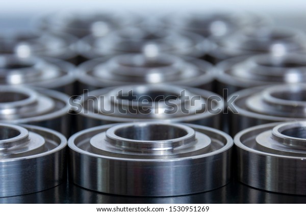 Abstract technical\
background for design and project. Metal parts machined on a lathe.\
Machined industrial\
parts.