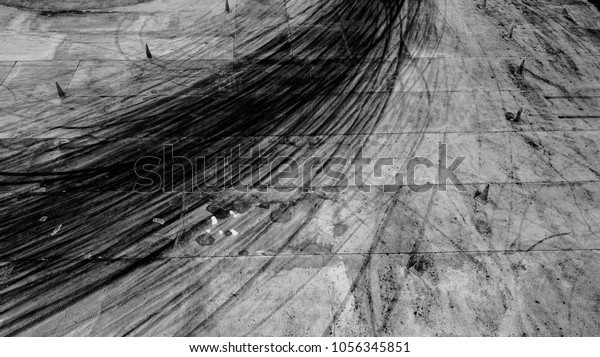 Abstract texture and background black tire\
tracks skid on asphalt road, Wheel tire tracks background, Car tire\
track skid mark on race track background, Above view, Automobile\
and automotive\
concept.