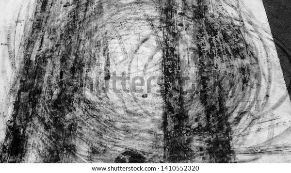 Abstract texture and background black tire\
tracks skid on asphalt road, Wheel tire tracks background, Car tire\
track skid mark on race track background, Above view, Automobile\
and automotive\
concept.