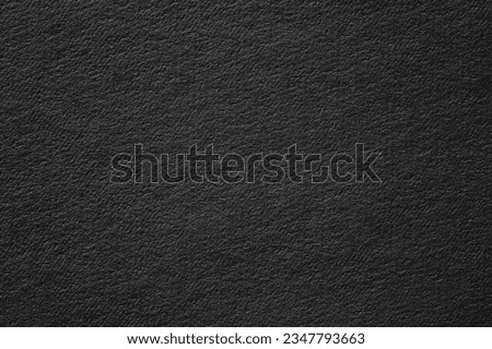 abstract texture of black poster. dark paper background with vignette 