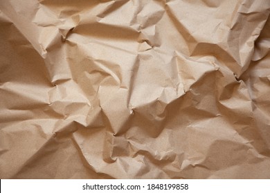 Abstract texture. Crumpled craft brown paper background. Copy space for text. Horizontal. DIY, handicraft, back to school, ecology, plastic free concept, harvesting for mock up. Flat lay, top view.