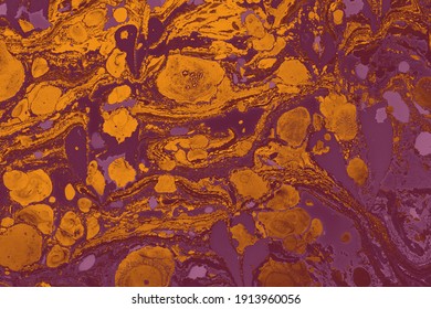 An abstract texture of mixed purple and orange oil based paint - cool for wallpaper