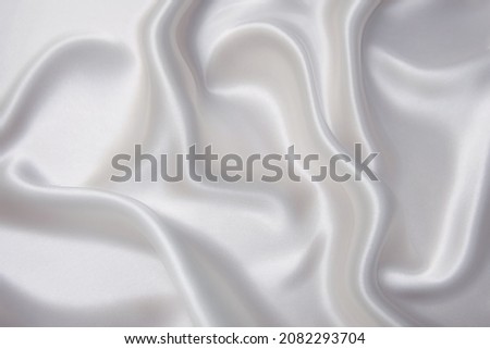 Abstract texture of natural light color fabric as concept background. Fabric texture of natural cotton or linen, silk or satin, wool or jersey textile material. Luxurious white canvas background.