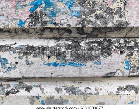 Abstract texture of old weathered wall with peeling paint, cracks, and mold stains.
