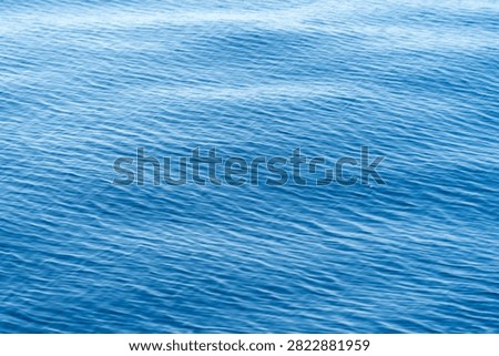Abstract texture of small waves and water patterns reflecting sunlight on the vast expanse of the Atlantic Ocean