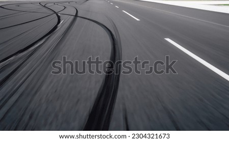 Abstract texture surface and background of car tire drift skid mark on road race track, Black tire mark on street race track, Automobile and automotive concept. High quality image
