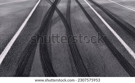 Abstract texture surface and background of car tire drift skid mark on road race track, Black tire mark on street race track, Automobile and automotive concept. High quality image
