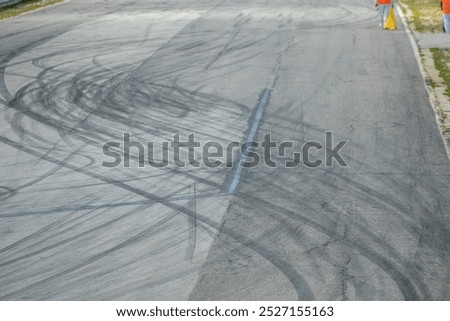 Abstract texture surface and background of car tire drift skid mark on road race track, black tire mark on asphalt race track. Automotive concept background