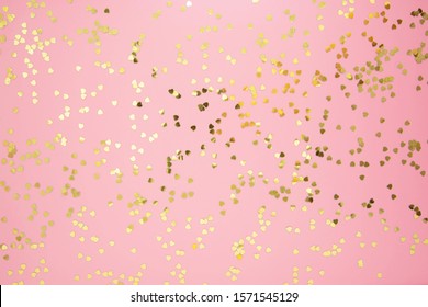 Abstract textured backgraund, golden heart shape glitter over pink background. Valentine's Day, love, birthday, party concept. Flat lay with space for text. - Powered by Shutterstock