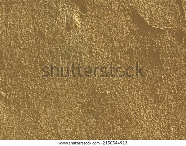 Abstract textured background of light yellow\
color. Side lighting highlights relief. Roughly plastered surface.\
It looks like desert top view. Grunge background for creative\
design. Copy space\
