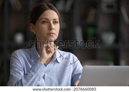 Abstract thinking, search solution, brainwork, business vision, future opportunity, goals concept. Pensive serious businesswoman sit at workplace take off glasses, deep in thoughts, look into distance