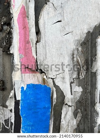 Abstract torn street poster bits on  worn urban wall background