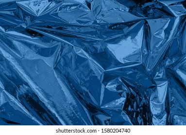 Abstract Trendy Dark Blue Colored Crumpled Foil Texture Background. Color Trend Concept.