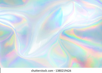 Abstract trendy holographic background. Real texture in pale violet, pink and mint colors with scratches and irregularities