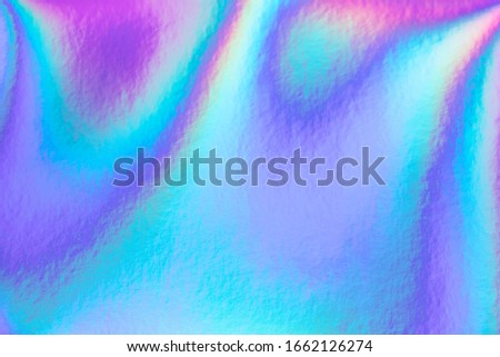 Abstract trendy rainbow holographic background in 80s style. Blurred texture in violet, pink and mint Bright neon colors.