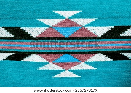 Abstract tribal pattern as background. Geometric chevron pattern blue fabric. Selective focus close up. Traditional pattern backdrop. Horizontal lines and triangle shape forming a geometric pattern.