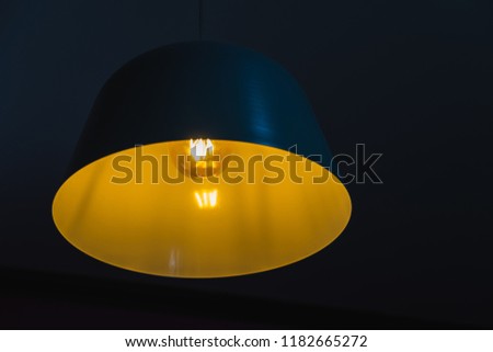 Abstract Tungsten vintage lamp with dark background with space for text