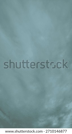 Abstract turquoise sky background with soft, blurry cloud patterns. Minimalistic atmospheric texture ideal for design, presentations, and creative projects.
