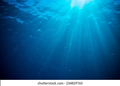 abstract underwater scene sunrays and air bubbles in deep blue sea - Shutterstock ID 234829765