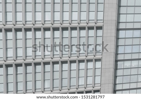 Abstract urban background featuring detail of modern tall office buildings in downtown Tokyo, Japan, with windows textures. 