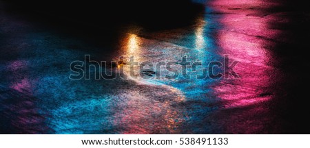 Abstract urban background. Lights and shadows of New York City. NYC streets after rain with reflections on wet asphalt. 