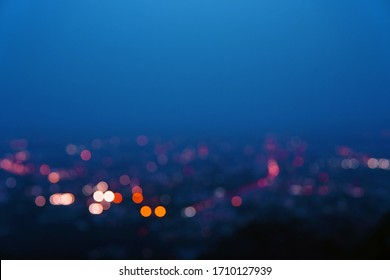 Abstract Urban Light In Twilight Time With Blue Sky In A Bird's Eye View, City Night Light Bokeh With Copy Space. Defocused Background.