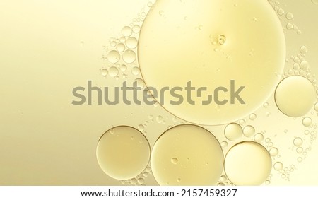 Abstract various yellow bubbles oil or serum with copy space background banner. cosmetic or spa ingredient concept