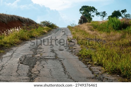 Abstract view of an empty road in the middle of nowhere, quiet landscape scene with minimal composition and a sense of isolation and open journey.