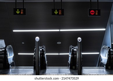 Abstract view of escalators in Metro station used to transport commuters during rush hour. The signs in Japanese says "Automatic"