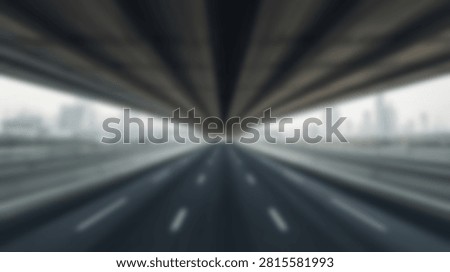 An abstract view looking down a highway underpass with a strong motion blur effect creating a sense of speed and movement.