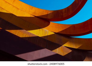 Abstract view of a modern sculptural architecture with vibrant red and yellow curves.