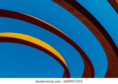 Abstract view of a modern sculptural architecture with vibrant red and yellow curves.
