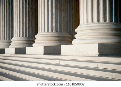 Abstract view of neoclassical fluted columns, bases and steps of the US Supreme Court building in Washington DC