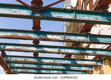 Abstract view of old steel girders, looking upwards to old steel construction.