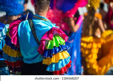 Abstract view of samba dancers in colorful frilled costumes at a daytime Carnival street party in Rio de Janeiro, Brazil