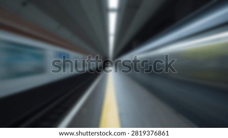 Abstract view of a train in motion at a subway station platform, conveying speed and movement with blurred lines and light streaks.