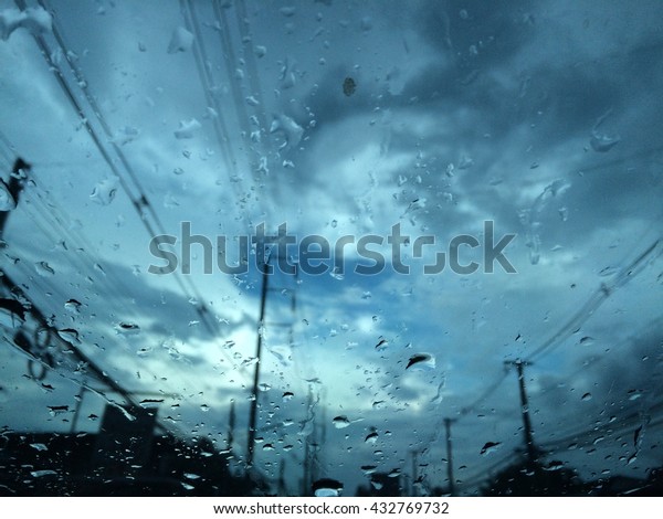 abstract view\
from the window at the rain, thunder and lightning with drops on\
the glass, soft focus and vintage\
color