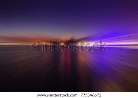 An abstract wallpaper of glowing motion sunset color light gliding across smooth ocean.