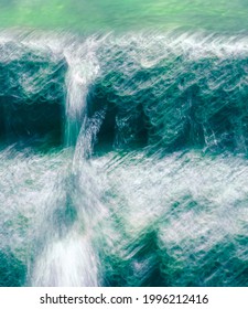 Abstract Water Cascade Photo Impression Background. Artistic Wild Motion Blurred Mass Of Water In Teal Blue, White And Neon Green Colors. Stop-motion Picture Photograph. Waterfall Vertical Layout.