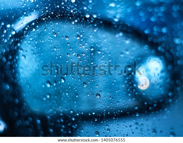 Abstract\
water drop with car side window out of\
focus