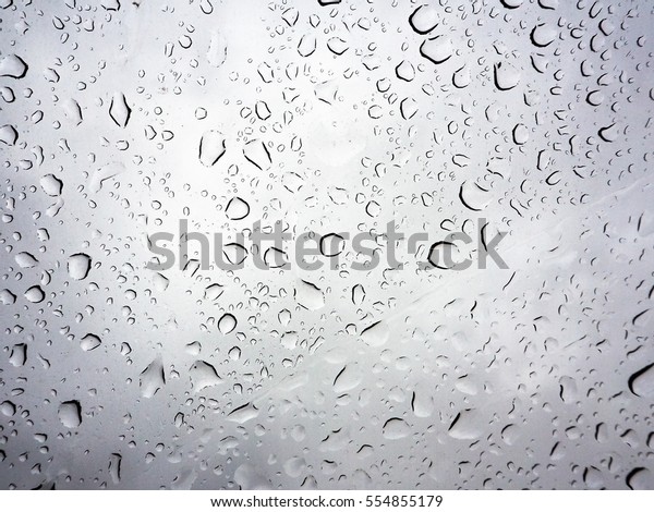 Abstract of water droplets on mirror with\
blurred  background.
