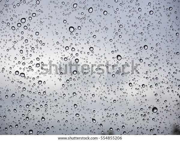 Abstract of water droplets on mirror with\
blurred  background.\
