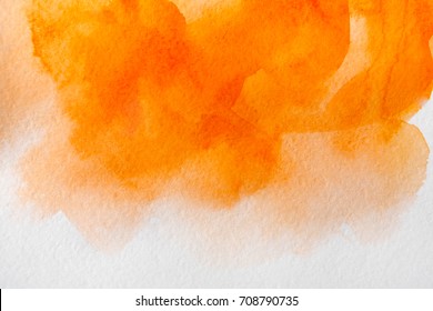 Abstract watercolor yellow and orange spot painted texture background.
